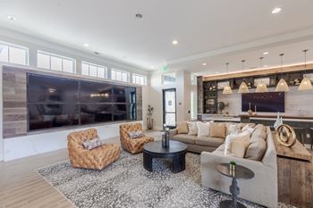 A living room with a couch, two chairs, and a coffee table.